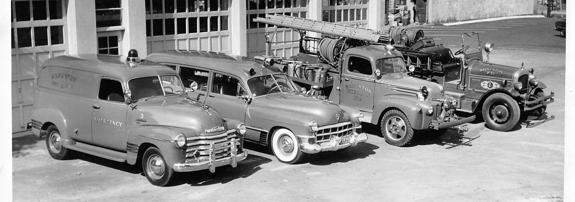 Old firetrucks and ambulances black and white photo